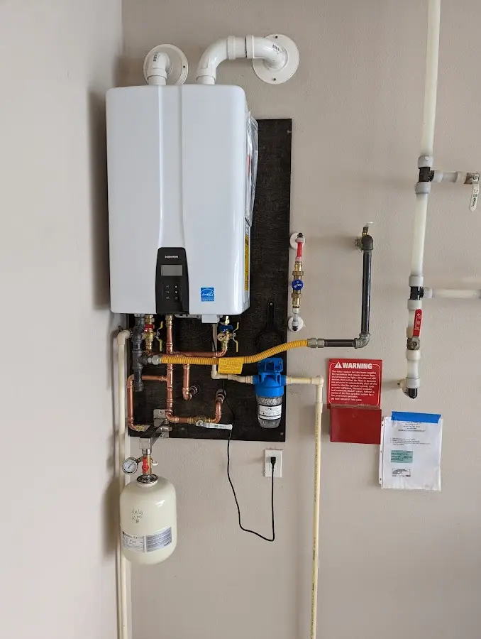 Professional plumber installing copper piping in a Pikesville home